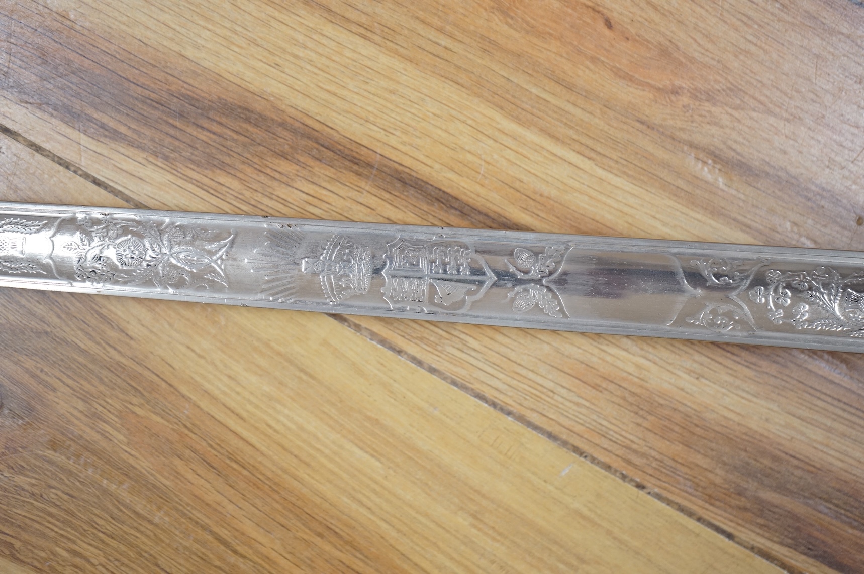 A George V 1897 pattern infantry officer’s sword, with regulation blade etched with the union flowers, Royal Arms and owners name; J.W. Reynolds, Dorrington, Lincoln, regulation nickel guard stamped ‘WH&S’ in minuscules,